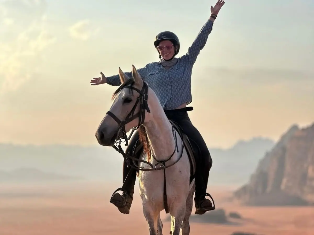 Horse riders crossing the Wadi Rum desert with a local guide